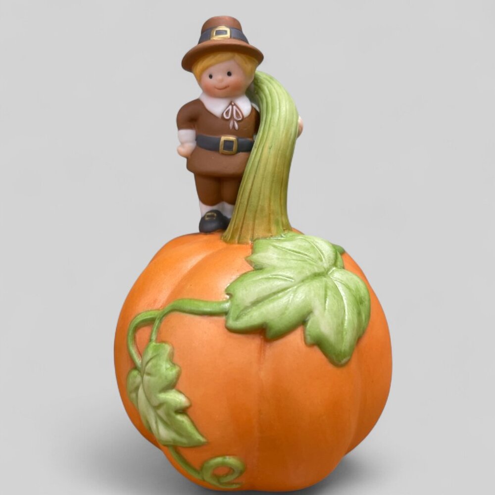 Avon Giving Thanks Porcelain Bell- featuring a Pilgrim perched on a Pumpkin